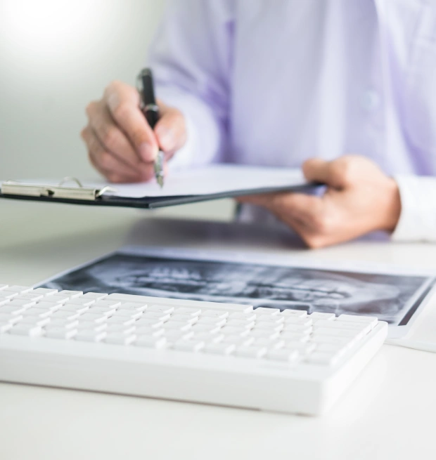 Person reviewing dental insurance and payment documents