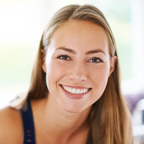 Smiling woman against a light background