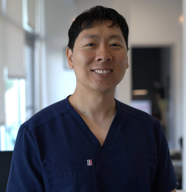 Dr. Daniel Kou smiling in the dental office