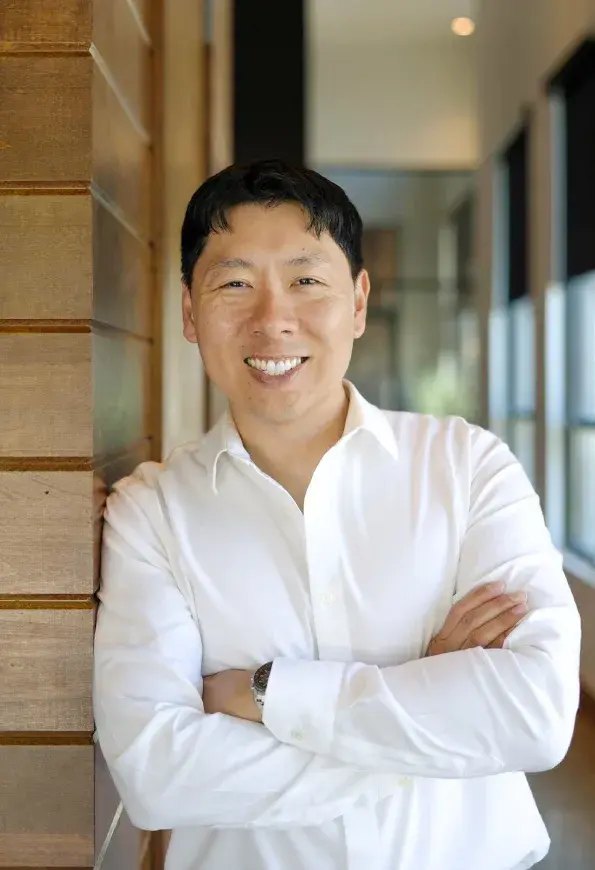 Dr. Daniel Kou, dentist at Frisco dental practice, smiling in professional portrait.